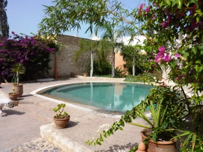 Double bedroom and spacious garden with swimming pool