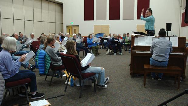 Choir members practice in a new church 