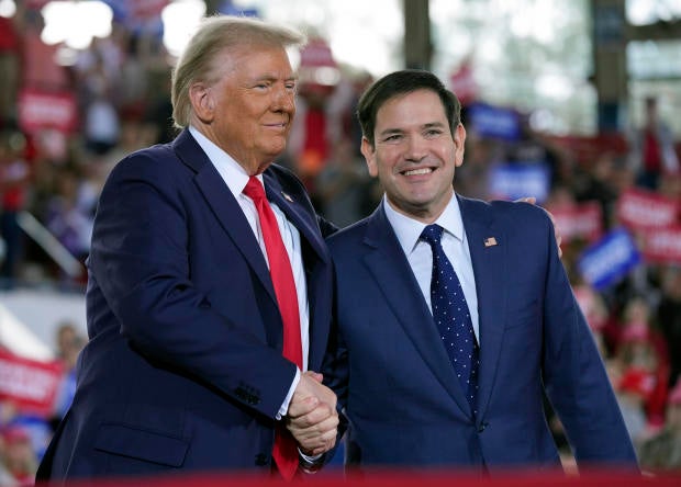 Former President Donald Trump shakes hands with Sen. Marco Rubio 