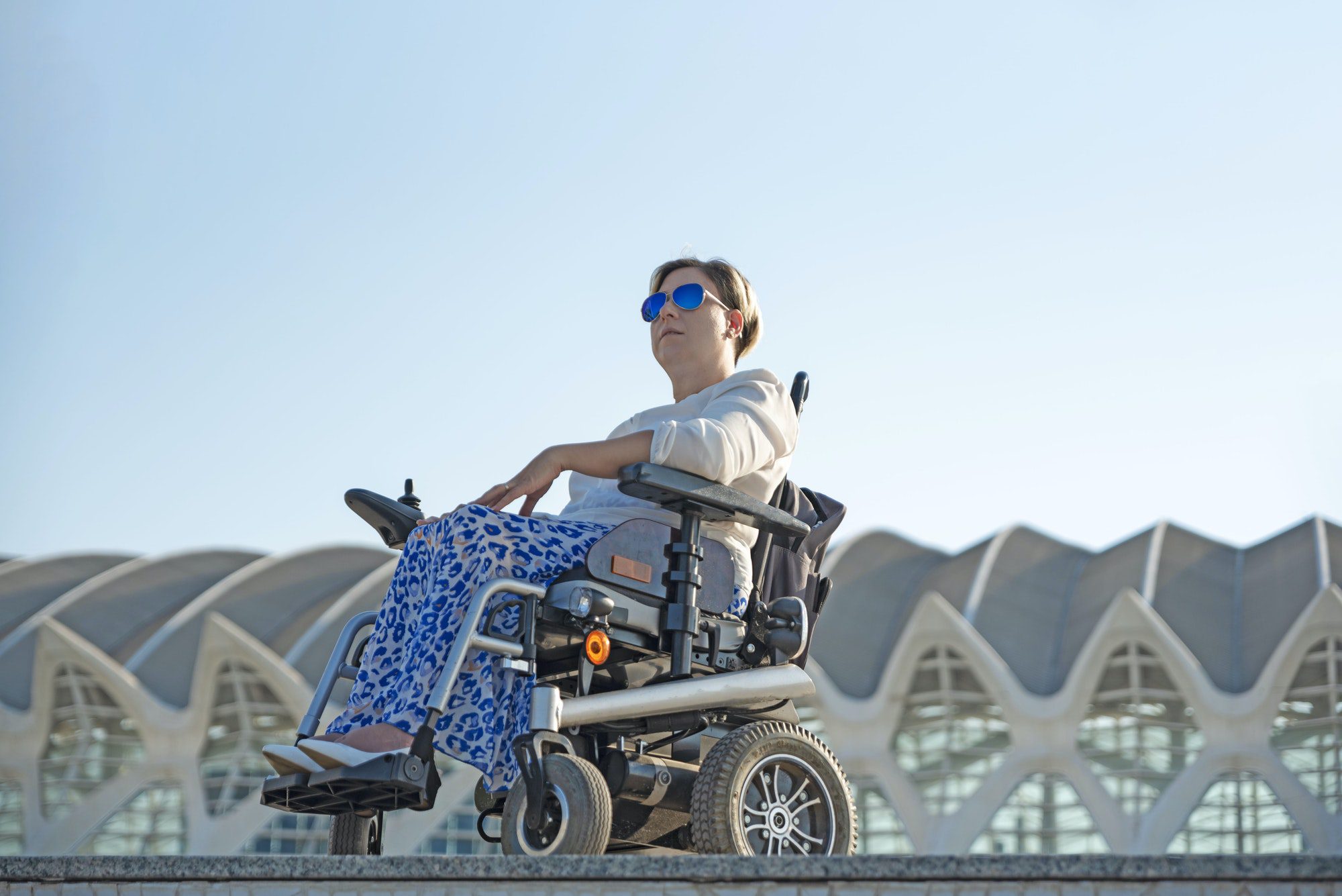 a woman with disability in a wheelchair in the city