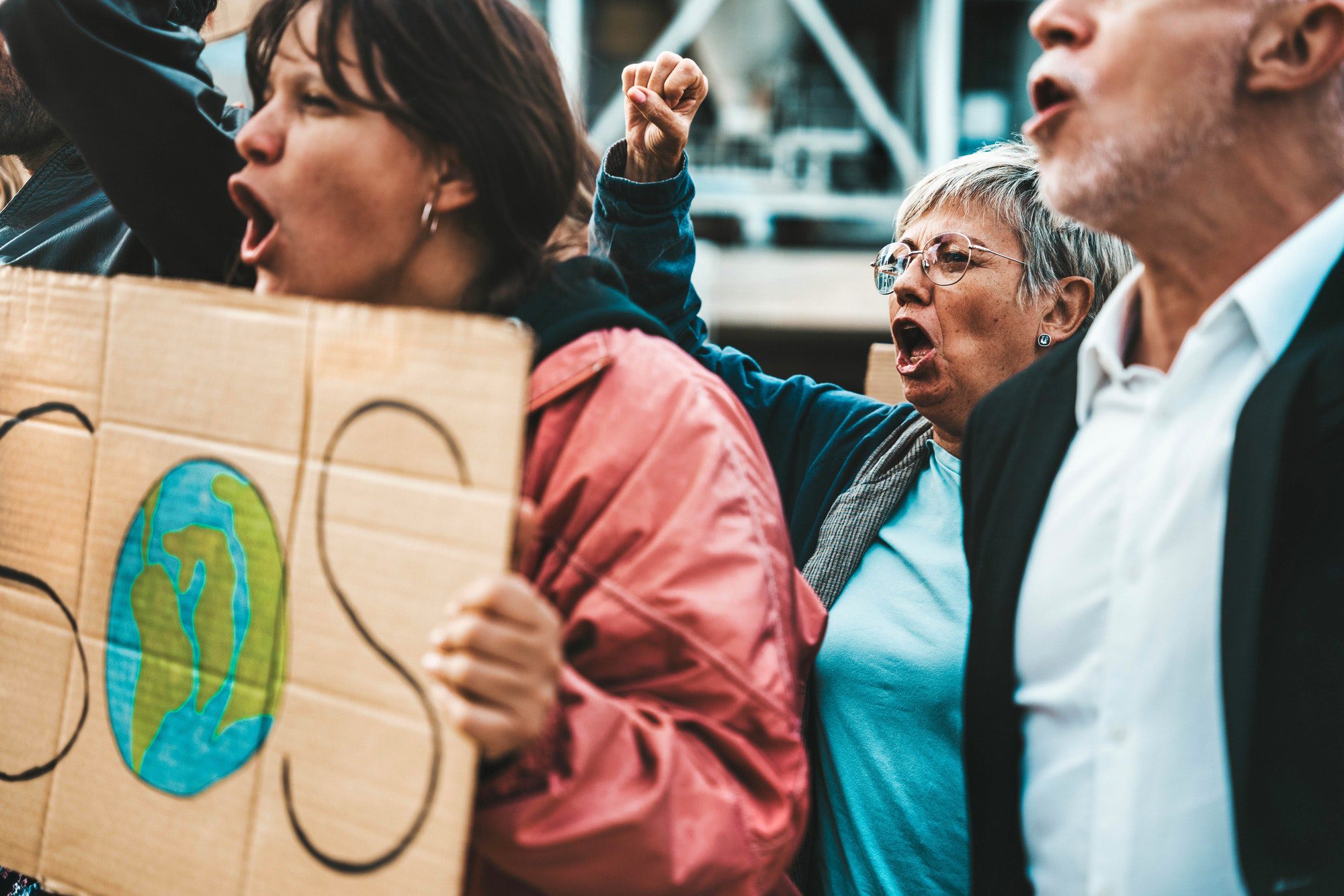 Group of activists carrying posters protesting against global warming and climate change