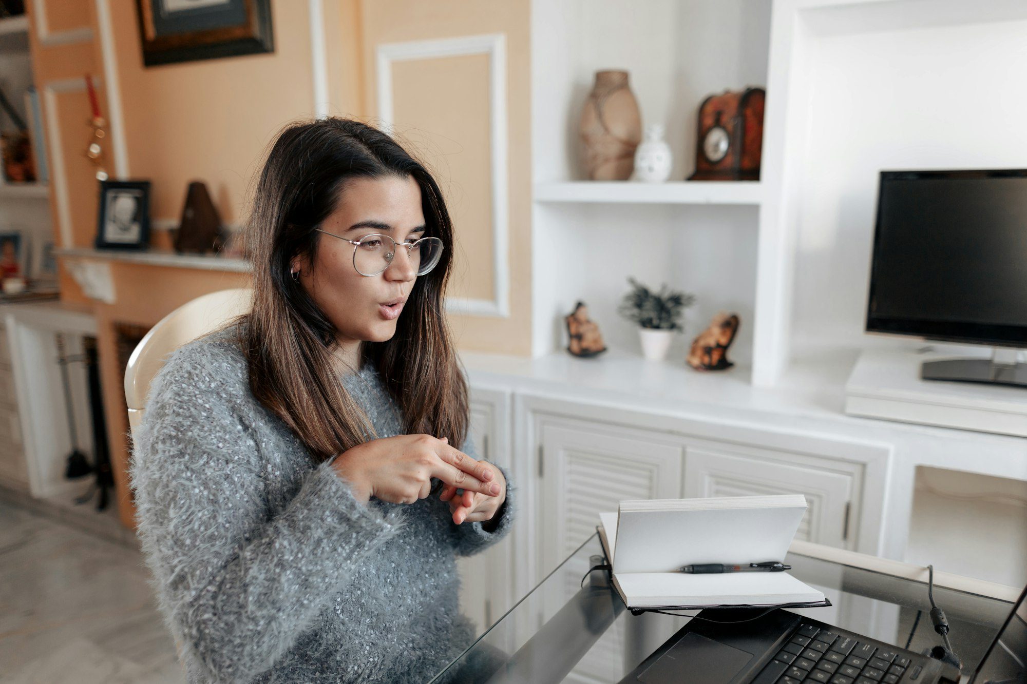 Young deaf woman having a non verbal conversation in online video call