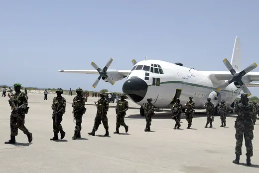 Ugandan soldiers, part of the first African Union peacekeepers, walk of a plane at Mogadishu airport.