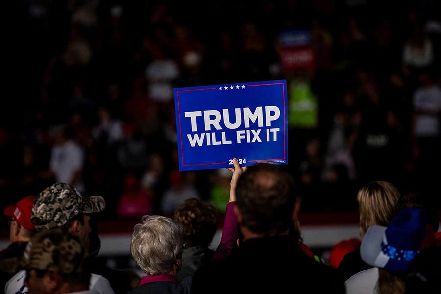 An attendee holds up a sign reading "Trump will fix it" ahead of a campaign rally with former U.S. President Donald Trump in Grand Rapids, Michigan.