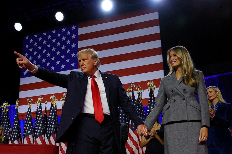 President-Elect Donald Trump holds hands with his wife, Melania, at a rally in West Palm Beach, Florida.