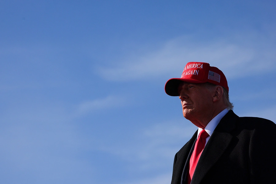 U.S. President Donald Trump wears a red "Make America Great Again" hat.