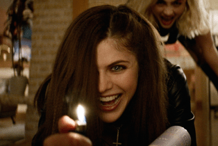 Alexandra Daddario ignites a lighter.