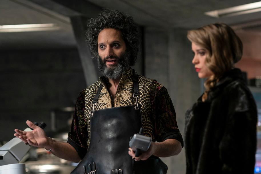 Pictured: Jason Mantzoukas as Artisan and Sophie Cookson as Nora of the Paramount+ original movie INFINITE