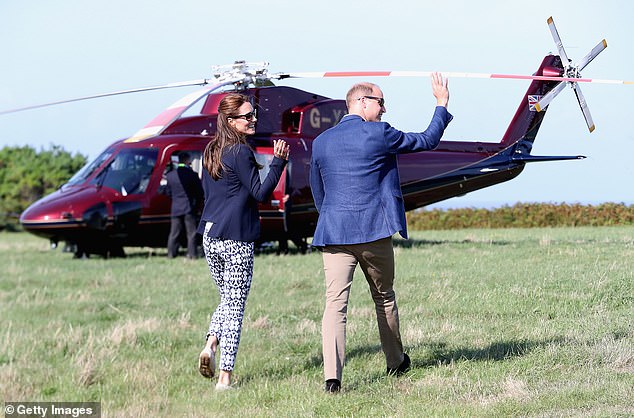 The Prince and Princess of Wales wave as they head back to the Royal helicopter after visiting the island of St Martin's in the Isles of Scilly in 2016