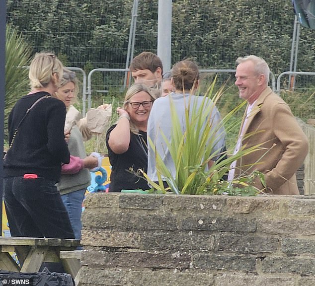 The presenter (left) was seen laughing and smiling with her ex-husband Norman, aka Fatboy Slim (right), outside a café in Hove on Thursday