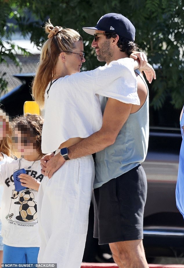 Justin Baldoni shares a lingering kiss with his wife Emily amid the fallout from behind-the-scenes tensions during the production of It Ends with Us. His wife vowed to stand by him when they married in their emotional vows