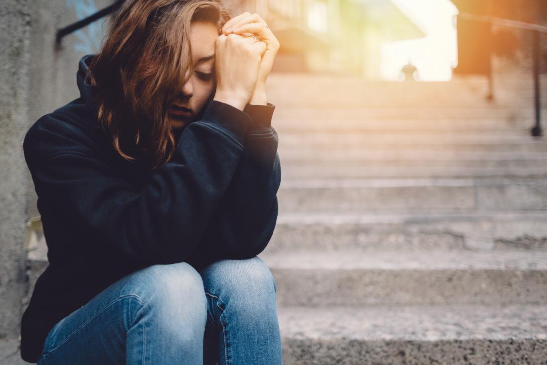 depressed woman sitting on steps