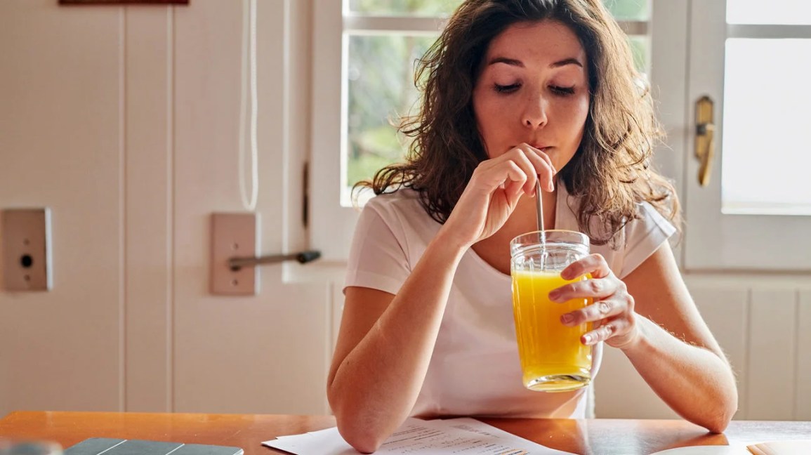 A woman drinking fruit juice