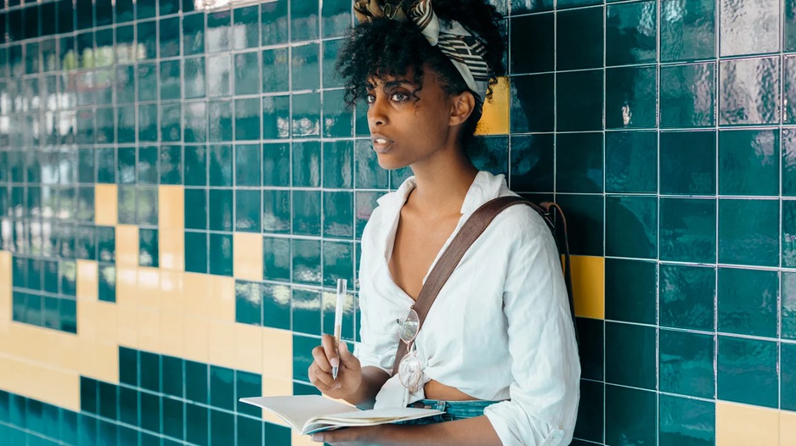 woman writing affirmations for anxiety in a notebook