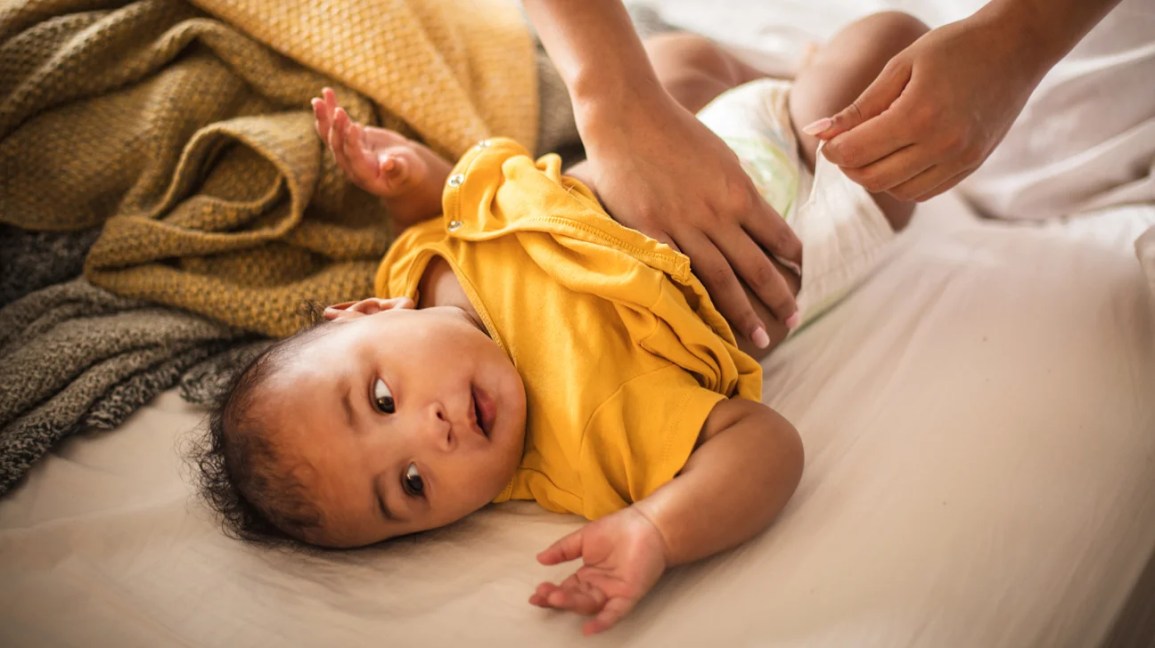 Baby having diaper changed