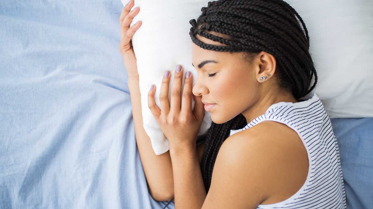 Woman resting head on pillow falling asleep