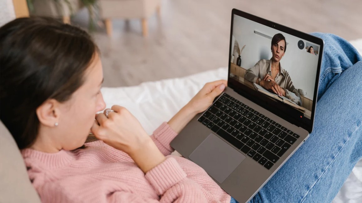 concerned woman looking at laptop