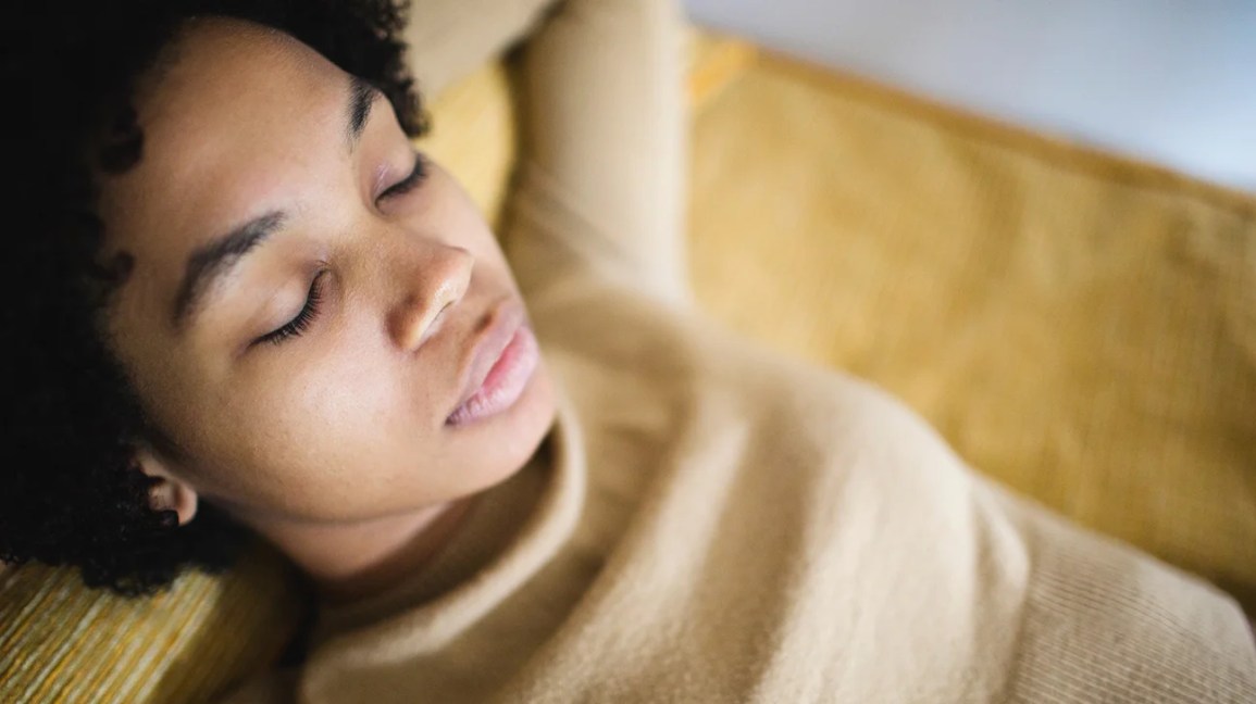 woman lying down with eyes closed