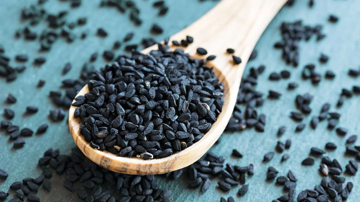 Nigella sativa seeds in wooden spoon