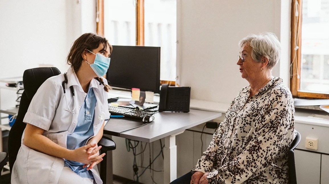 A person meets with a doctor.