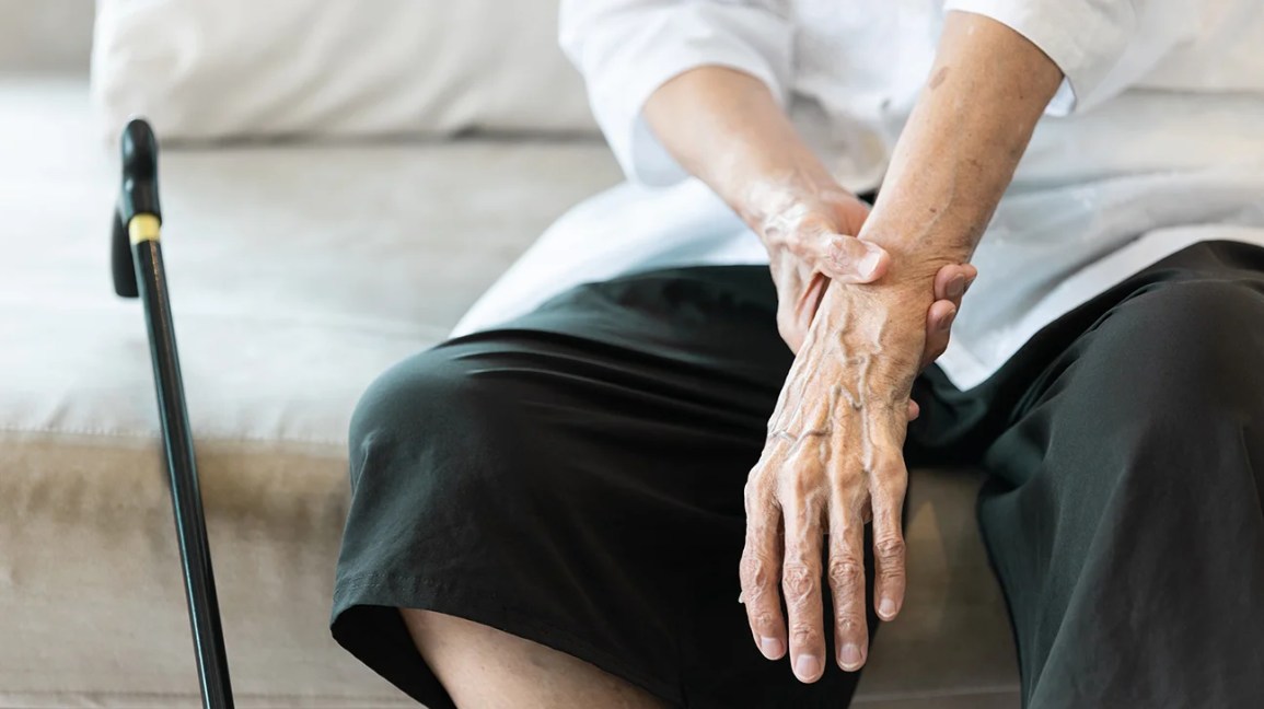 Senior woman with hand tremor