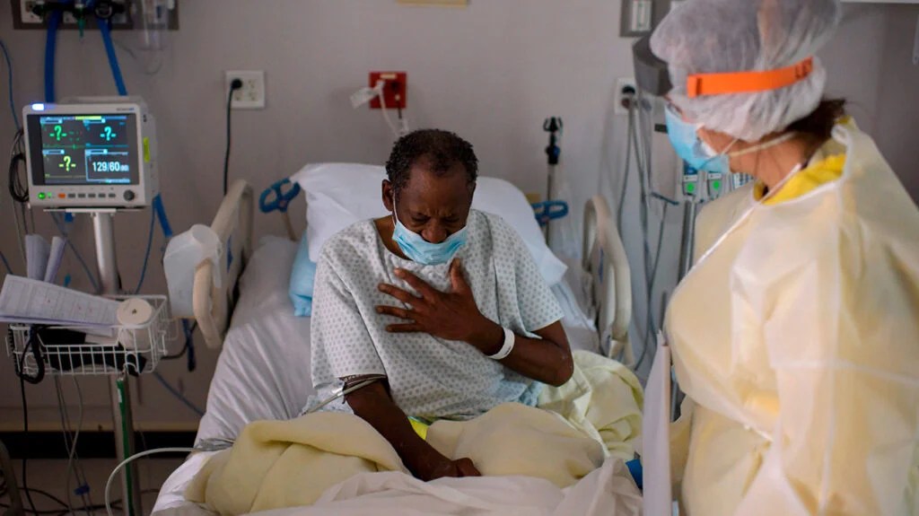 Healthcare worker tends to a patient in the COVID-19 Unit at United Memorial Medical Center in Houston, TX on July 2, 2020