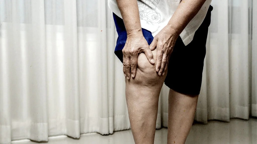 A person holding their knee.