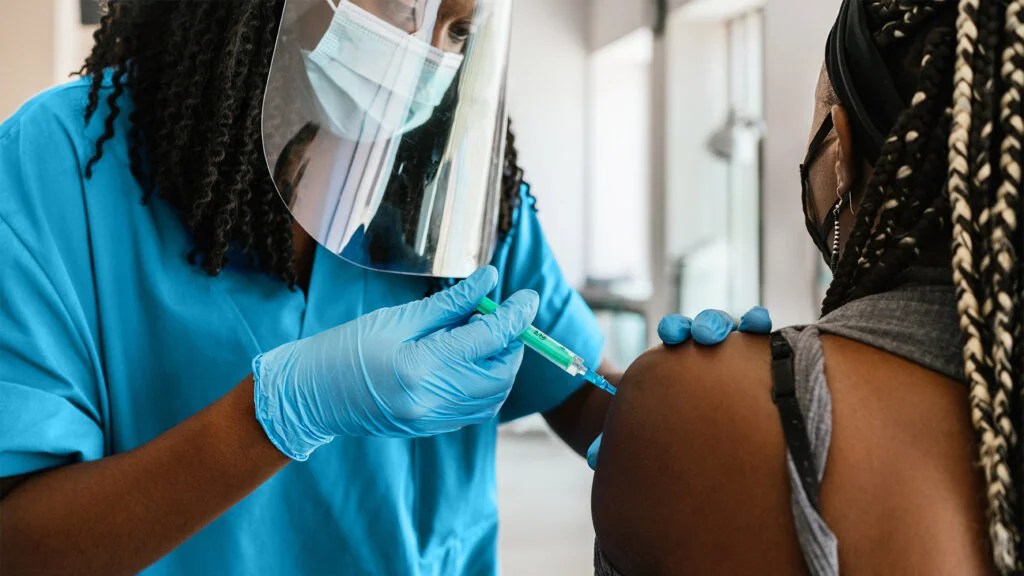 person receiving a vaccine shot