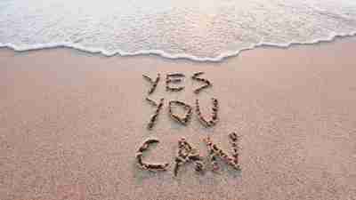 yes you can, motivational inspirational message concept written on the sand of beach