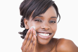 Woman of color using skin cream