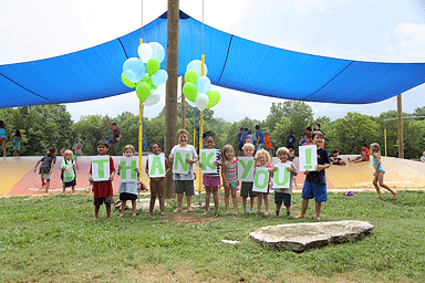 kids in front of a shade structure