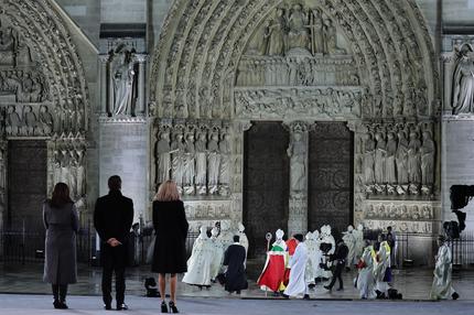 Notre-Dame: Mayor of Paris Anne Hidalgo (L), French President Emmanuel Macron (2L) and his wife Brigitte Macron (3R) stand as the Archbishop of Paris, Bishop Ulrich walks to the doors of Notre-Dame Cathedral during a ceremony to mark the re-opening of the landmark Cathedral, in central Paris, on December 7, 2024. Around 50 heads of state and government are expected in the French capital to attend the ceremony marking the rebuilding of the Gothic masterpiece five years after the 2019 fire which ravaged the world heritage landmark and toppled its spire. Some 250 companies and hundreds of experts were part of the five-year restoration project at a cost of hundreds of millions of euros.