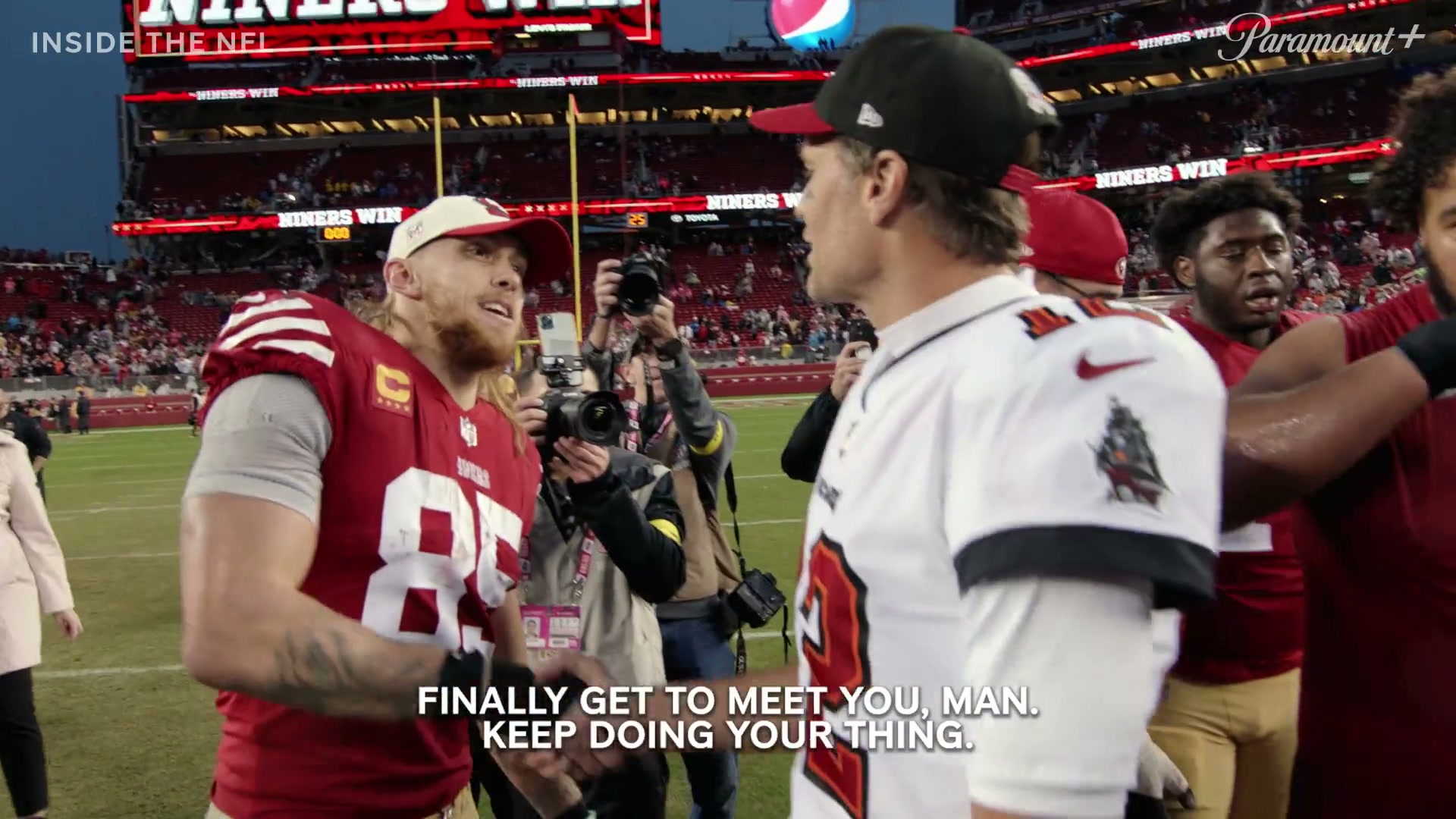 George Kittle shaking hands with Tom Brady. "Finally got to meet you, man. Keep doing your thing."