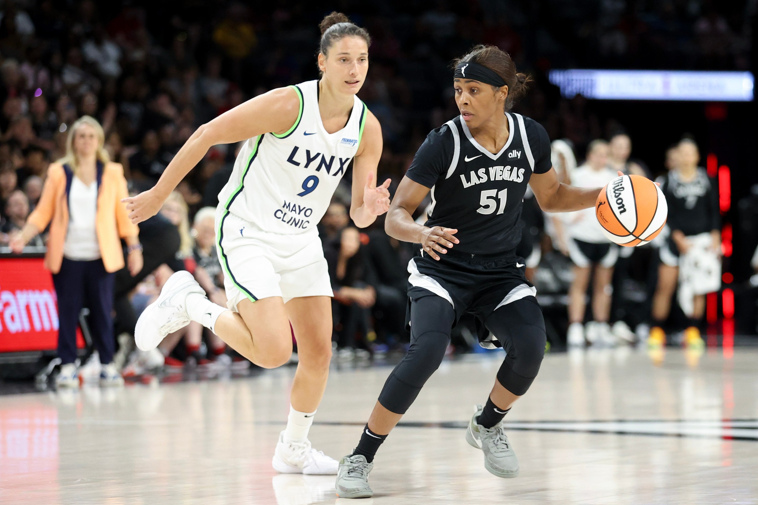 Sydney Colson #51 of the Las Vegas Aces drives against Cecilia Zandalasini #9 of the Minnesota Lynx in the fourth quarter of their game at Michelob ULTRA Arena on August 21, 2024 in Las Vegas, Nevada.