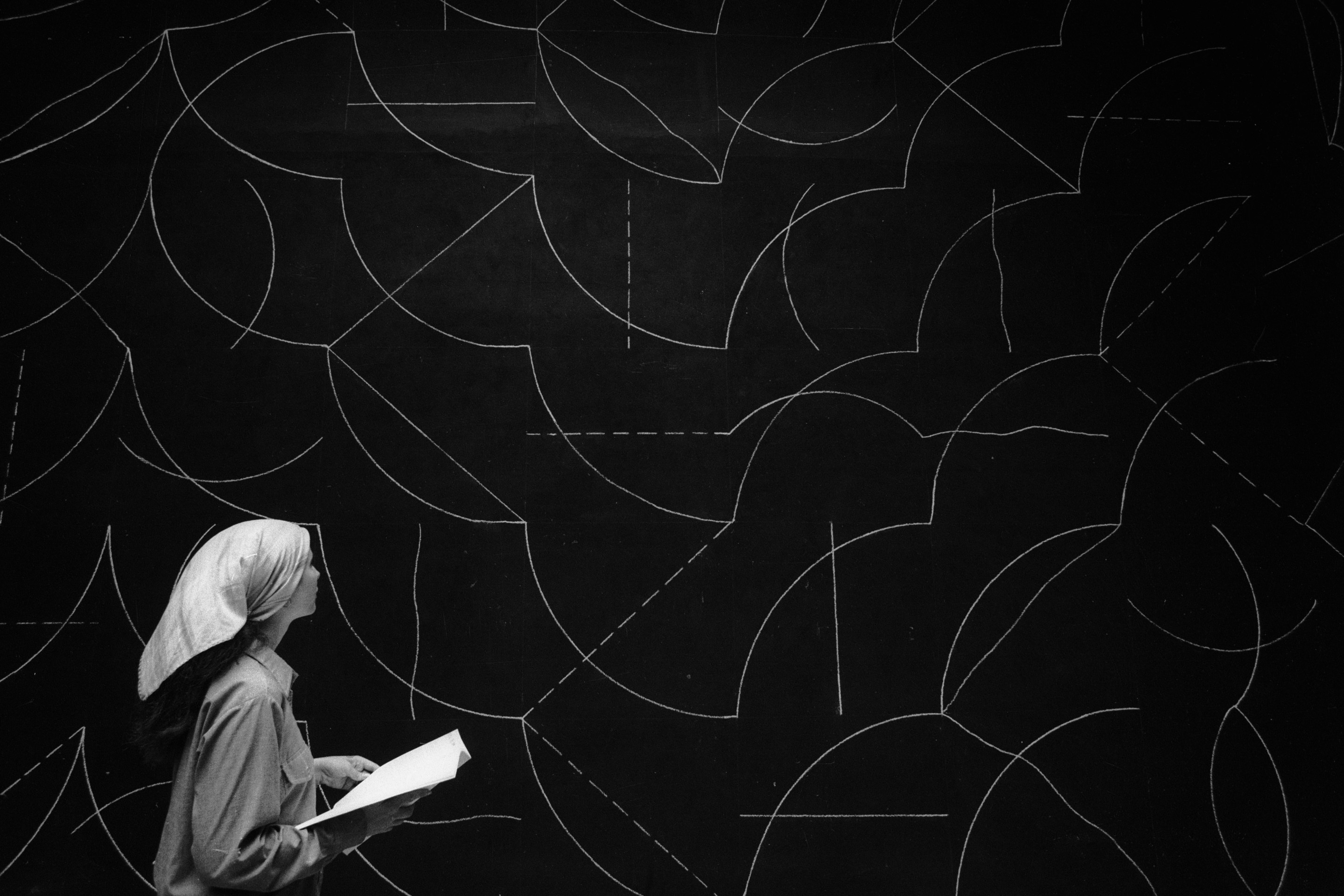 A woman stands in front of a Sol LeWitt wall drawing at the Venice Biennale in 1976.