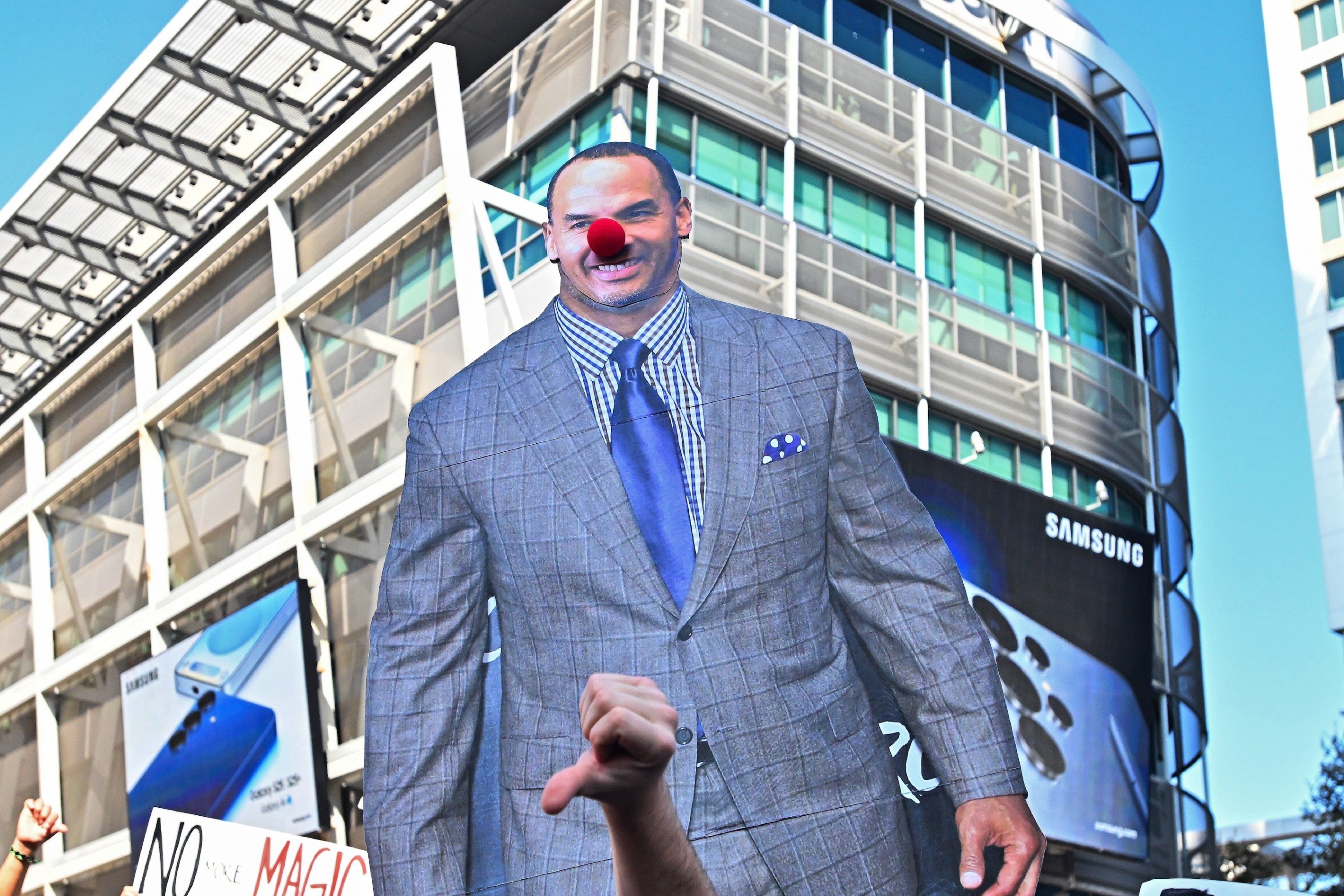 Dallas Mavericks fans lift a cutout of general manager Nico Harrison with a clown nose during a protest of the trade of Los Angeles Lakers point guard Luka Doncic outside the American Airlines Center.