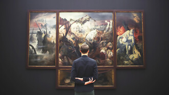 A man admiring a painting under expertly designed museum lighting in an art gallery, highlighting the impact of exhibition space illumination