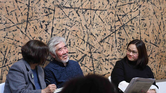 Young-Sup Han (m) in conversation with Hyewon Yi (r) interpreted by Chan K.P.Gillham (l) on November 16, 2023 at Sylvia Wald and Po Kim Gallery. The painting behind them is Relation No. 9150, 1991, Ink on Korean mulberry paper, 72 x 196.8 inches (183 x 500 cm)