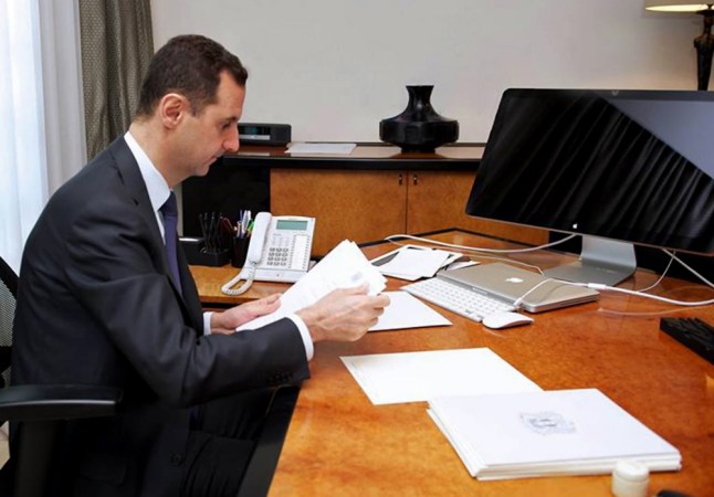 A picture released on the official page of the Presidency of the Syrian Arab Republic on the internet social network site Facebook shows Syria's President Bashar al-Assad in his office in the capital Damascus on June 13, 2013. The advance of Syrian regime forces on opposition strongholds has thrust into the spotlight a fractious debate on whether Western nations should arm the rebels, with no decision yet in sight. AFP PHOTO / FACEBOOK == RESTRICTED TO EDITORIAL USE - MANDATORY CREDIT "AFP PHOTO / FACEBOOK" - NO MARKETING NO ADVERTISING CAMPAIGNS - DISTRIBUTED AS A SERVICE TO CLIENTS ==-/AFP/Getty Images