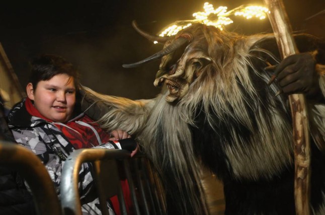 NEUSTIFT IM STUBAITAL, AUSTRIA A participant dressed as the Krampus creature in search of delinquent children approaches a little boy during Krampus night in Neustift im Stubaital, Austria. Sixteen Krampus groups including over 200 Krampuses participated in the first annual Neustift event. Krampus, in Tyrol also called Tuifl, is a demon-like creature represented by a fearsome, hand-carved wooden mask with animal horns, a suit made from sheep or goat skin and large cow bells attached to the waist that the wearer rings by running or shaking his hips up and down. Krampus has been a part of Central European, alpine folklore going back at least a millennium, and since the 17th-century Krampus traditionally accompanies St. Nicholas and angels on the evening of December 5 to visit households to reward children that have been good while reprimanding those who have not. However, in the last few decades Tyrol in particular has seen the founding of numerous village Krampus associations with up to 100 members each and who parade without St. Nicholas at Krampus events throughout November and early December. (Picture: Getty)