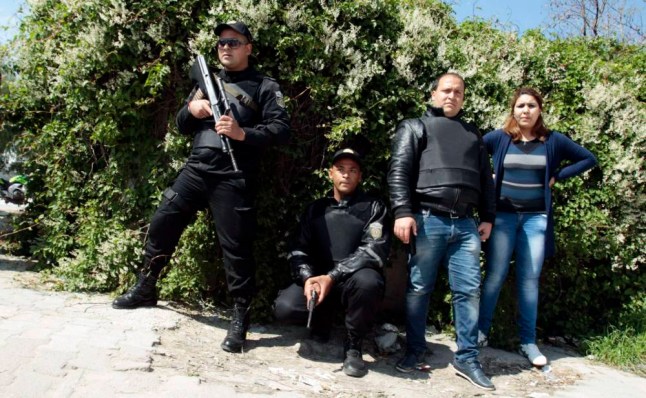 Police officers stand outside parliament in Tunis March 18, 2015. Gunmen attacked Tunisia's national museum near its parliament on Wednesday, killing at least seven tourists and taking others hostage inside the building, the government said. REUTERS/Zoubeir Souissi (TUNISIA - Tags: CIVIL UNREST POLITICS CRIME LAW)