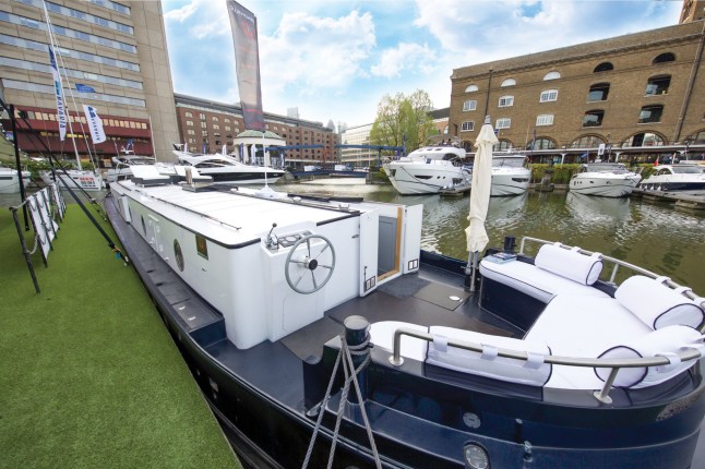 A supercar dealer fed up with Londonís property prices has swapped mortar for water by building a luxury houseboat for £300,000.  See SWNS story SWBOAT.  Alex Prindivilleís two bedroom floating home boasts a log burning stove, granite worktop and power shower.  But instead of having to pay more than £1 million for a similarly-sized flat on St Katherine Docks in East London he paid less than one third of the price.  The businessman found a master boat-builder in Sheffield who hand-made a steel boat with the space and finish to turn his dream into reality.  It was then fitted with pressure-jet central heating with ësmart controlí, full electrics, hot and cold running water, dish washer, washing machine, solid wood flooring and a skylight.