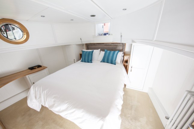 The master bedroom.  A supercar dealer fed up with Londonís property prices has swapped mortar for water by building a luxury houseboat for £300,000.  See SWNS story SWBOAT.  Alex Prindivilleís two bedroom floating home boasts a log burning stove, granite worktop and power shower.  But instead of having to pay more than £1 million for a similarly-sized flat on St Katherine Docks in East London he paid less than one third of the price.  The businessman found a master boat-builder in Sheffield who hand-made a steel boat with the space and finish to turn his dream into reality.  It was then fitted with pressure-jet central heating with ësmart controlí, full electrics, hot and cold running water, dish washer, washing machine, solid wood flooring and a skylight.