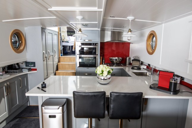 The kitchen.  A supercar dealer fed up with Londonís property prices has swapped mortar for water by building a luxury houseboat for £300,000.  See SWNS story SWBOAT.  Alex Prindivilleís two bedroom floating home boasts a log burning stove, granite worktop and power shower.  But instead of having to pay more than £1 million for a similarly-sized flat on St Katherine Docks in East London he paid less than one third of the price.  The businessman found a master boat-builder in Sheffield who hand-made a steel boat with the space and finish to turn his dream into reality.  It was then fitted with pressure-jet central heating with ësmart controlí, full electrics, hot and cold running water, dish washer, washing machine, solid wood flooring and a skylight.