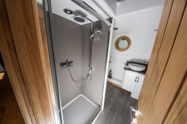 The shower.  A supercar dealer fed up with Londonís property prices has swapped mortar for water by building a luxury houseboat for £300,000.  See SWNS story SWBOAT.  Alex Prindivilleís two bedroom floating home boasts a log burning stove, granite worktop and power shower.  But instead of having to pay more than £1 million for a similarly-sized flat on St Katherine Docks in East London he paid less than one third of the price.  The businessman found a master boat-builder in Sheffield who hand-made a steel boat with the space and finish to turn his dream into reality.  It was then fitted with pressure-jet central heating with ësmart controlí, full electrics, hot and cold running water, dish washer, washing machine, solid wood flooring and a skylight.