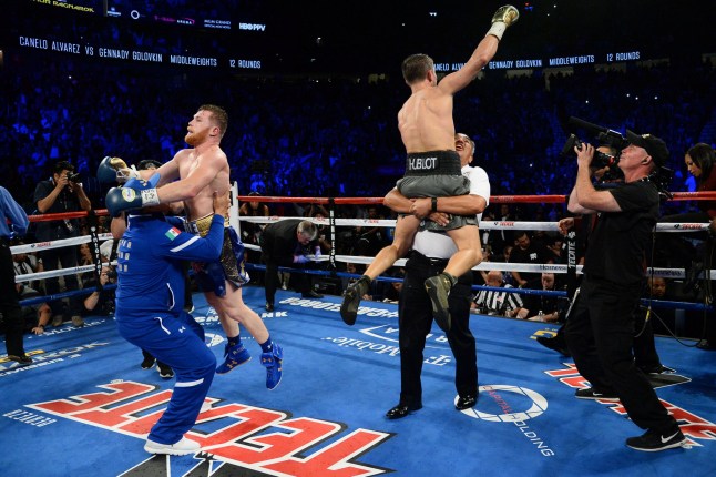 Sep 16, 2017; Las Vegas, NV, USA; Gennady Golovkin (green trunks) and Canelo Alvarez (blue trunks) celebrate after the world middleweight boxing championship at T-Mobile Arena. The bout ended in a draw. Mandatory Credit: Joe Camporeale-USA TODAY Sports TPX IMAGES OF THE DAY