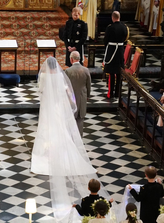 WINDSOR, UNITED KINGDOM - MAY 19: Prince Harry looks at his bride, Meghan Markle, as she arrived accompanied by Prince Charles, Prince of Wales during their wedding in St George's Chapel at Windsor Castle on May 19, 2018 in Windsor, England. (Photo by Owen Humphreys - WPA Pool/Getty Images)