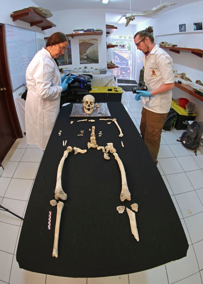 EMBARGOED TO 1900 WEDNESDAY FEBRUARY 5 Undated handout photo issued by Jeronimo Aviles/Plos One showing Professor Silvia Gonzalez (left) and Dr Sam Rennie (right) describing the Chan Hol 3 skull . PA Photo. Issue date: Wednesday February 5, 2020. The 10,000-year-old skeleton discovered in Mexico has challenged the theory that humans first entered the American continents as a single population. See PA story SCIENCE Paleoindian. Photo credit should read: Jeronimo Aviles Olgui/Plos One/PA Wire NOTE TO EDITORS: This handout photo may only be used in for editorial reporting purposes for the contemporaneous illustration of events, things or the people in the image or facts mentioned in the caption. Reuse of the picture may require further permission from the copyright holder.