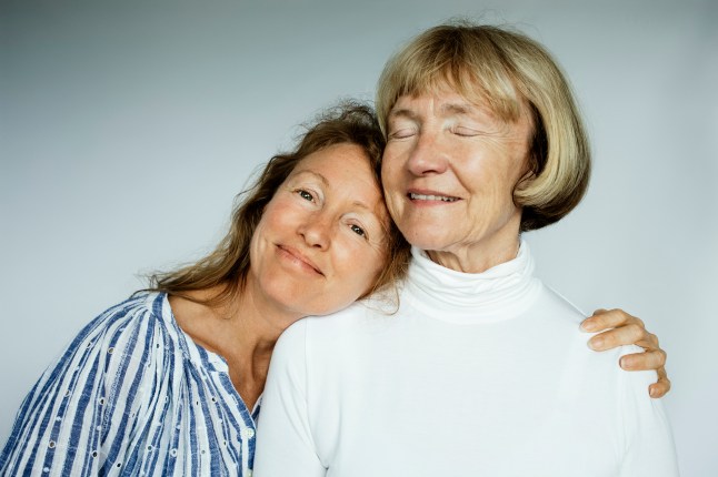 Portrait of mother and daughter on white background