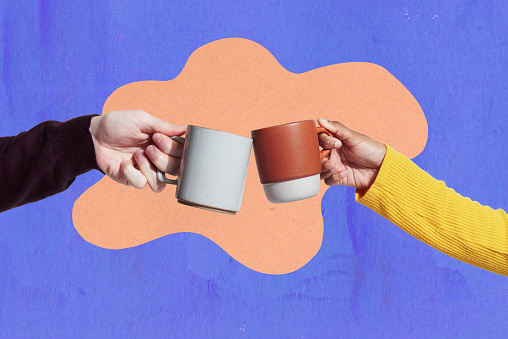 two coffee mugs touching